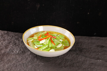 Freshly Stir-Fried Long Squash Vegetable Dish with Red Peppers in White Bowl