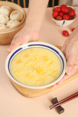 Healthy Millet Porridge Breakfast Bowl with Fresh Ingredients on Wooden Table