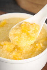 Healthy Yellow Millet Porridge in Bowl with Wooden Spoon - Nutritious Comfort Food
