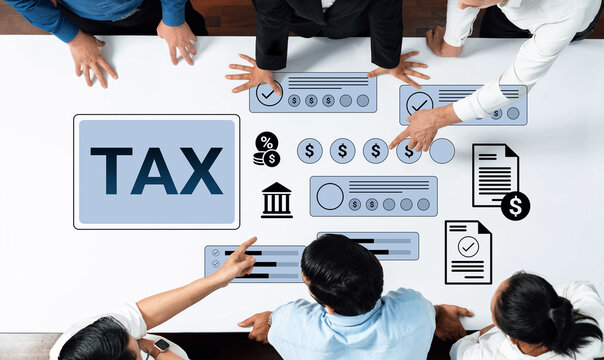 A diverse team collaborates around a large table, focusing on tax planning and financial analysis, with visual elements representing tax metrics and strategies. Gantry