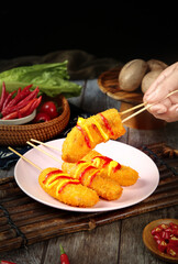 Fried Banana Skewers with Chili Garnish - Asian Street Food Snack on Wooden Table