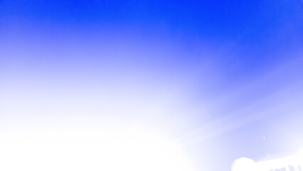 Dramatic white light rays radiate upward from a point source in the center, against a bright and deep electric blue background