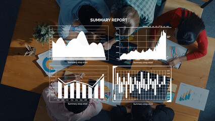 Overhead view of diverse professionals analyzing summary reports with graphs and charts in a collaborative workspace, showcasing teamwork and data-driven insights. Axiom