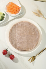 Fresh Buckwheat Pancakes with Vegetables and Wheat on White Background