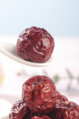Hang-Dried Jujube Dates from Hami Xinjiang on White Spoons - Traditional Chinese Dried Fruit