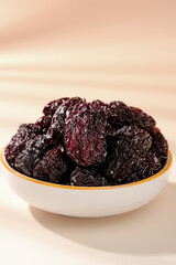 Dried Black Jujube Fruit from Xinjiang China in White Bowl - Healthy Traditional Snack Without Nucleus