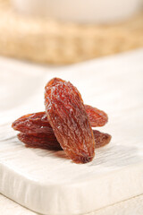 Xinjiang Red Raisins on White Wood Surface - Premium Dried Fruit Display