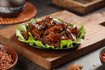 Roasted Quail Delicacy with Fresh Greens and Spices on Wooden Board - Gourmet Poultry Dish