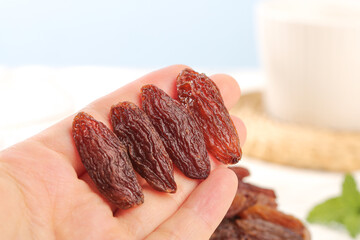 Xinjiang Ruby Red Raisins in Hand - Premium Quality Dried Fruits from China