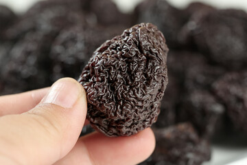 Dried Hibiscus Plum Fruit from Yongtai - Traditional Asian Preserved Snack Held in Hand
