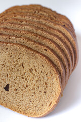 Stack of Slices of Fresh Brown Bread Isolated on White.