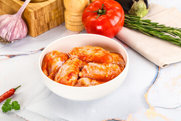 Raw marinated uncooked chicken wings