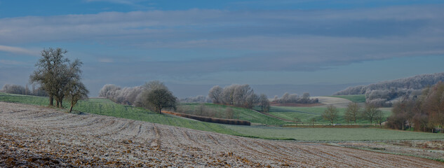Landscape photo taken in frosty temperatures in Kraichgau, Germany. Fields and forests covered in hoarfrost.