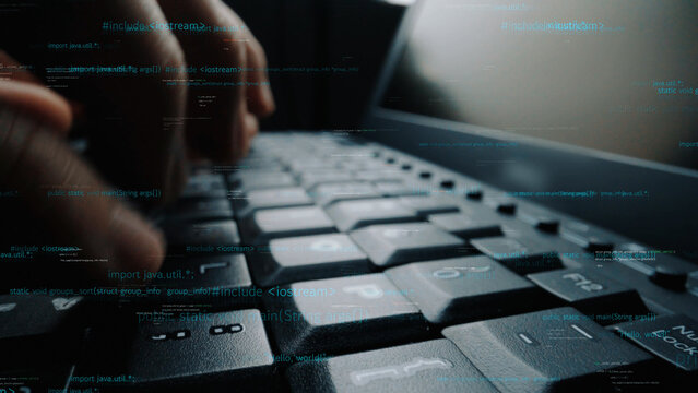 A close-up shot capturing hands actively typing on a laptop keyboard, with an overlay of glowing code, highlighting the importance of technology in daily tasks. Xenic