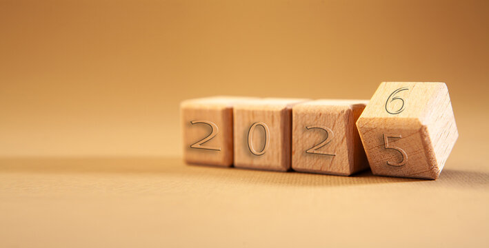 New Year 2026 concept with wooden cubes on a brown background with copy space - Powered by Adobe