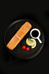 Norwegian Salmon Fillet with Lemon and Chili on Black Plate
