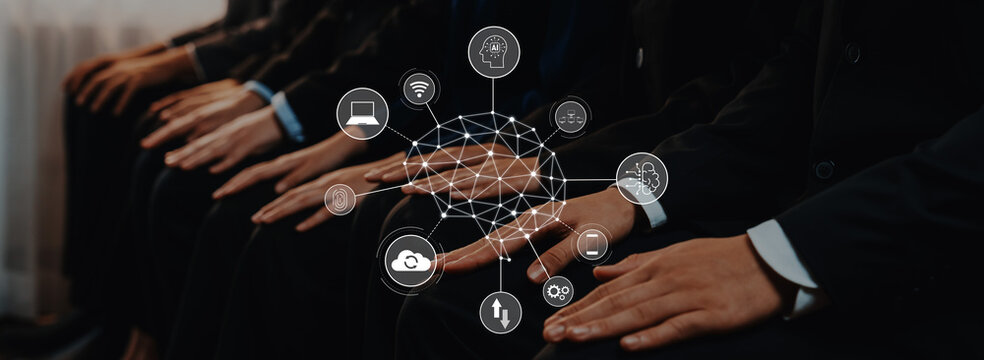 Group of business professionals sitting together, discussing strategies and innovations, surrounded by digital technology icons representing connectivity and data analysis. Trope