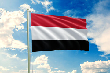 Realistic close-up of the Yemen flag waving on a tall flagpole under a bright sky with soft scattered clouds, showing smooth wind motion, sharp fabric details, vivid colors, and a clear sense 