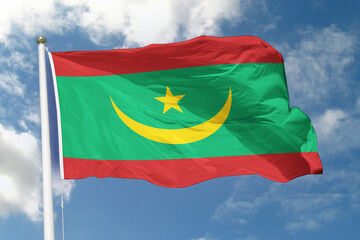 Naklejka premium Realistic close-up of the Mauritania flag waving on a tall flagpole under a bright sky with scattered clouds, showing smooth wind motion, vivid colors, and a strong sense of national pride. 