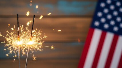 Sparkling celebration sparklers and american flag for fourth of july holiday