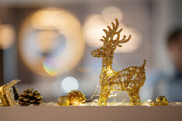 A decorative golden glitter reindeer figurine
