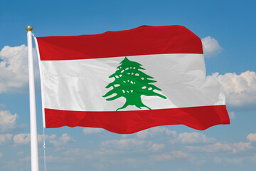 Realistic close-up of the Lebanon flag waving on a tall flagpole under a bright sky with soft scattered clouds, showing smooth wind motion, vivid colors, and a clear atmosphere of national pride.
