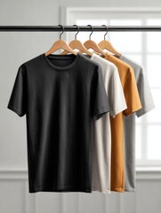 Colorful Assortment of T-Shirts on Wooden Hangers in Bright Room with Natural Light and Minimalist Background
