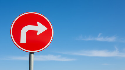Red traffic sign with right arrow against blue sky symbolizing direction and guidance 17306121 1