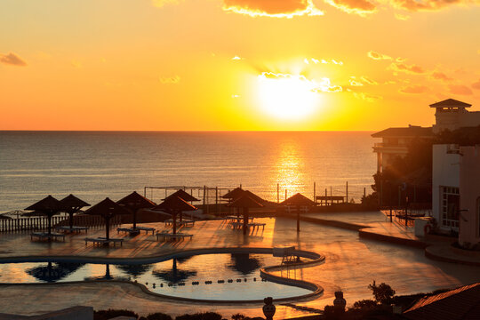 Luxury swimming pool with sea view at sunrise. Concept of rest, relaxation, holidays, resort
