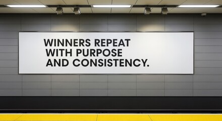 A motivational message on a wall about winners with purpose and consistency