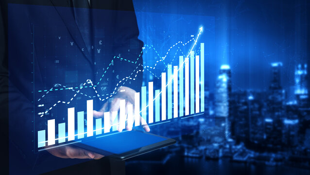 A businessman analyzes digital financial data displayed on a tablet, showcasing futuristic graphs and metrics against a vibrant urban backdrop at night. Impute