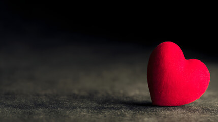 adoration. A red heart symbol stands out against a textured black background with a warm glow. wellbeing guides, coaching materials, designed for coaching and self-improvement content.