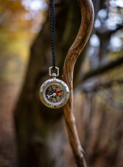 vintage compass on chain in forest