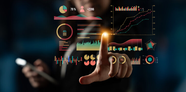 A business professional interacts with a digital touchscreen displaying colorful graphs and data insights in a modern office environment. Impute