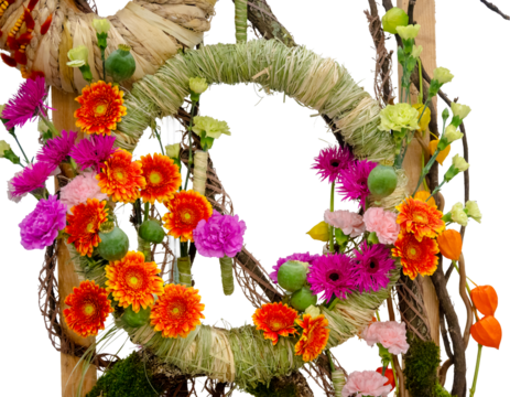 Vibrant floral spring wreath with gerberas, carnations, and natural elements like straw and twigs on a transparent background, perfect for Easter or seasonal designs.