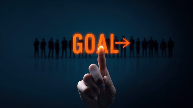 management team goal-setting. Finger pointing at the word "GOAL" with silhouettes in the background.