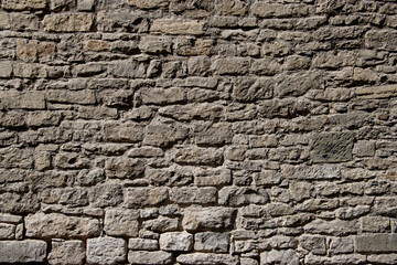 Weathered Stone Wall with Antique Texture Under Natural Light