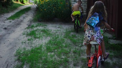 Two children, a boy and a girl, ride bicycles on a rustic dirt path during summer. Capturing childhood freedom and outdoor adventure, this image evokes nostalgia and simple joys of rural life.