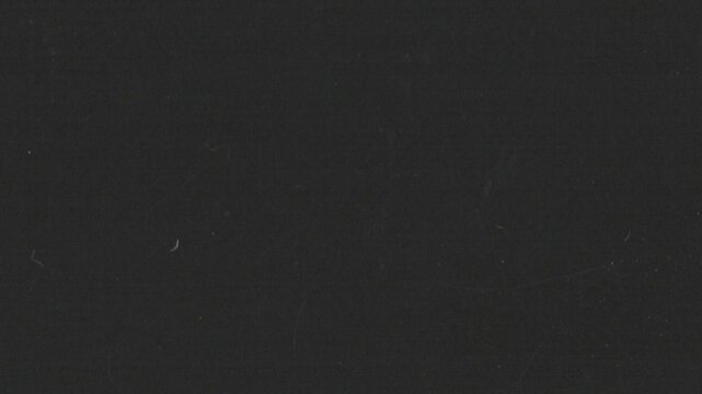 Vertical analog film grain loop with grind texture, dust and subtle imperfections. Ideal as an overlay or background for editors seeking authentic retro looks in vertical format.