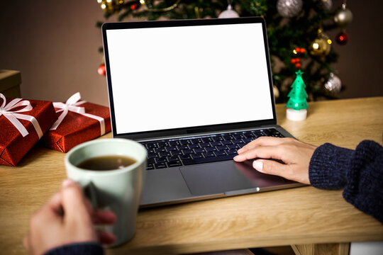 Christmas office holiday workspace with person typing on laptop showing blank screen to represent online celebration digital communication remote work productivity festive season creativity