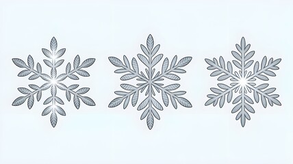 Three silver snowflakes with leaf like patterns arranged horizontally on a light blue background