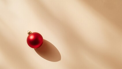 Minimal Christmas still life with red ornament on beige background, with copy space