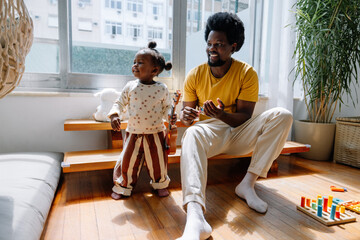 Family moment: father and daughter playing at home