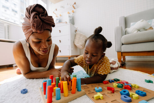 Mother and child play with colorful blocks
