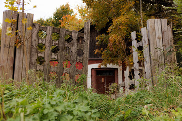 Rustic wooden gate opens to a hidden garden in autumn hues, inviting exploration and quiet reflection