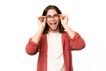 Young handsome man over isolated background with glasses and surprised