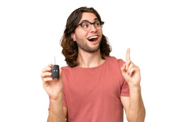 Young handsome man holding car keys over isolated background intending to realizes the solution while lifting a finger up