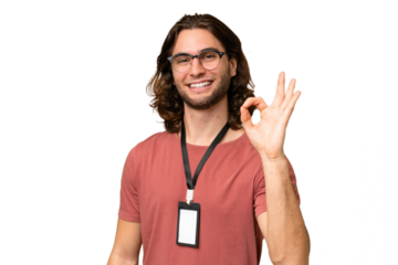 Young handsome man with ID card over isolated background showing ok sign with fingers