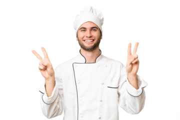 Young handsome chef man over isolated background showing victory sign with both hands