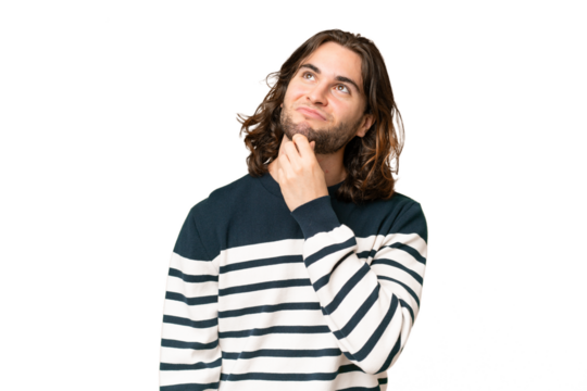 Young handsome man over isolated background and looking up